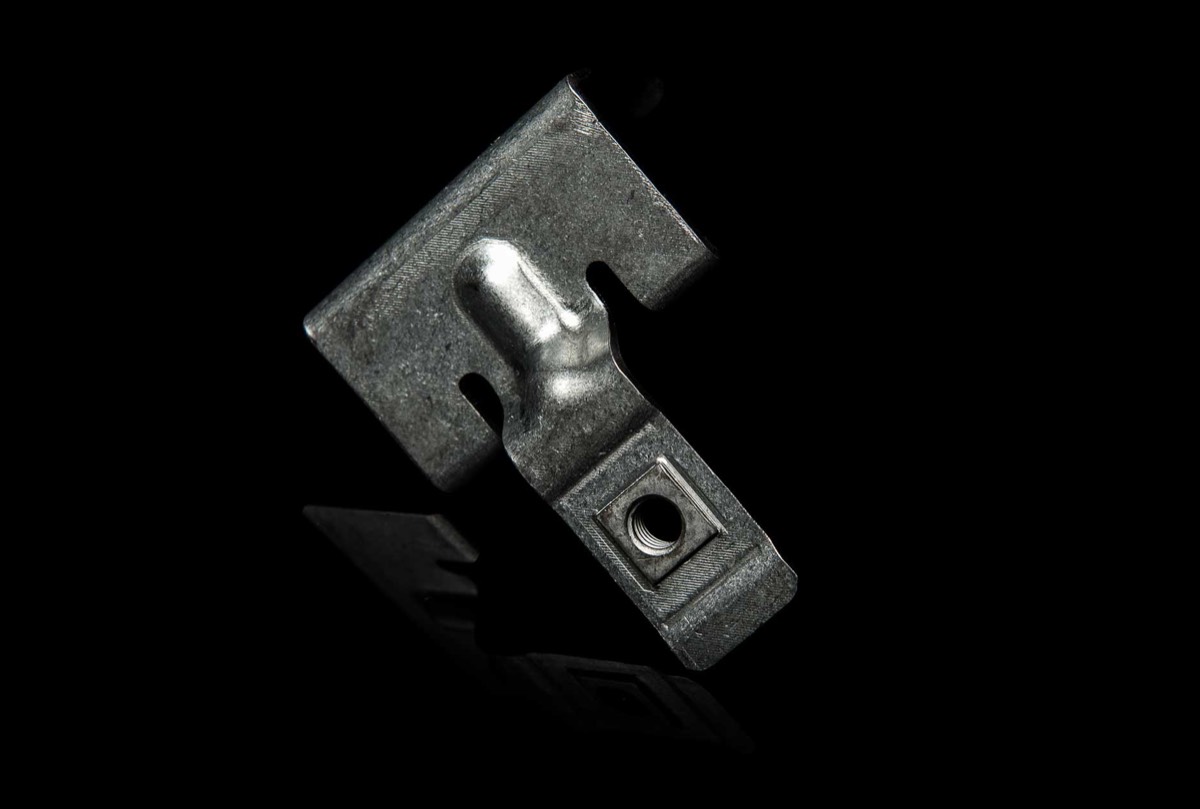 A stamped bracket with an installed clinch nut produced at Prototier-1